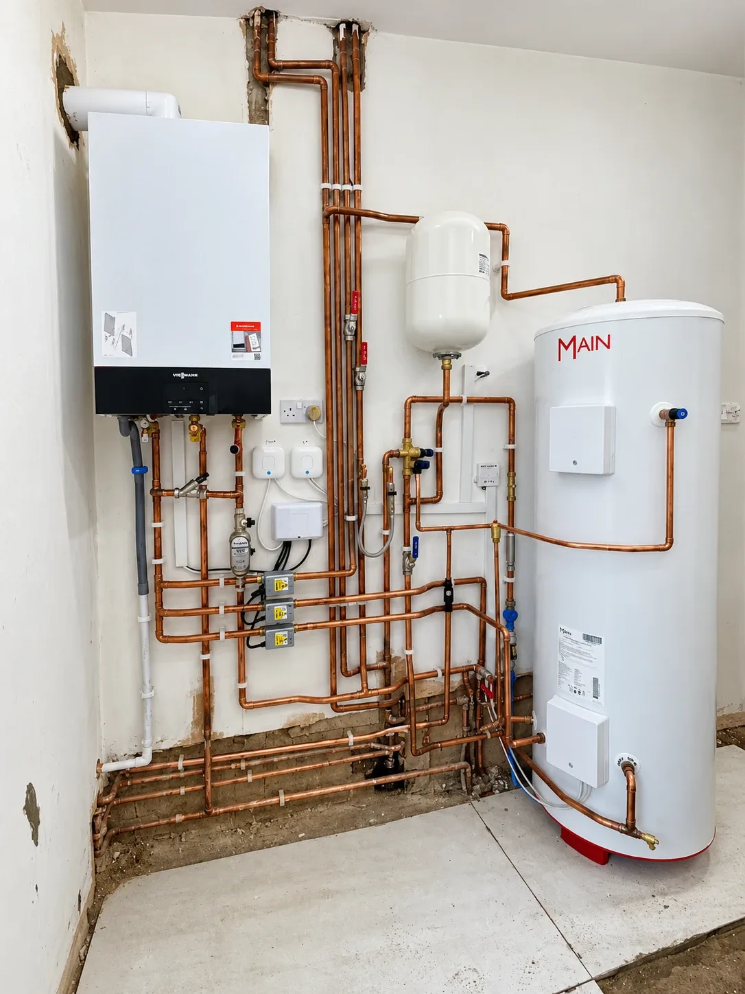 Wall-hung boiler with copper heating pipework and a hot water cylinder